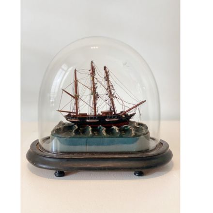 Scale model of a three-master under a glass dome