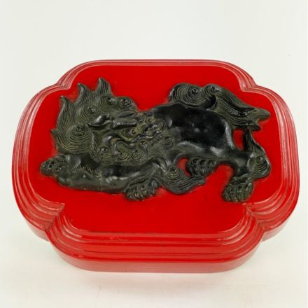 Pho dog in bronze on a red wooden base